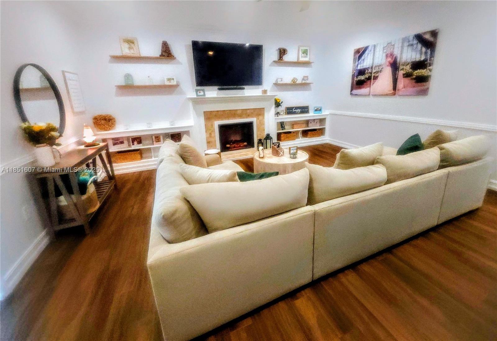 17833 Southwest 155th Court Miami, FL 33187 - Photo 17 of 22 a living room with furniture and a fireplace