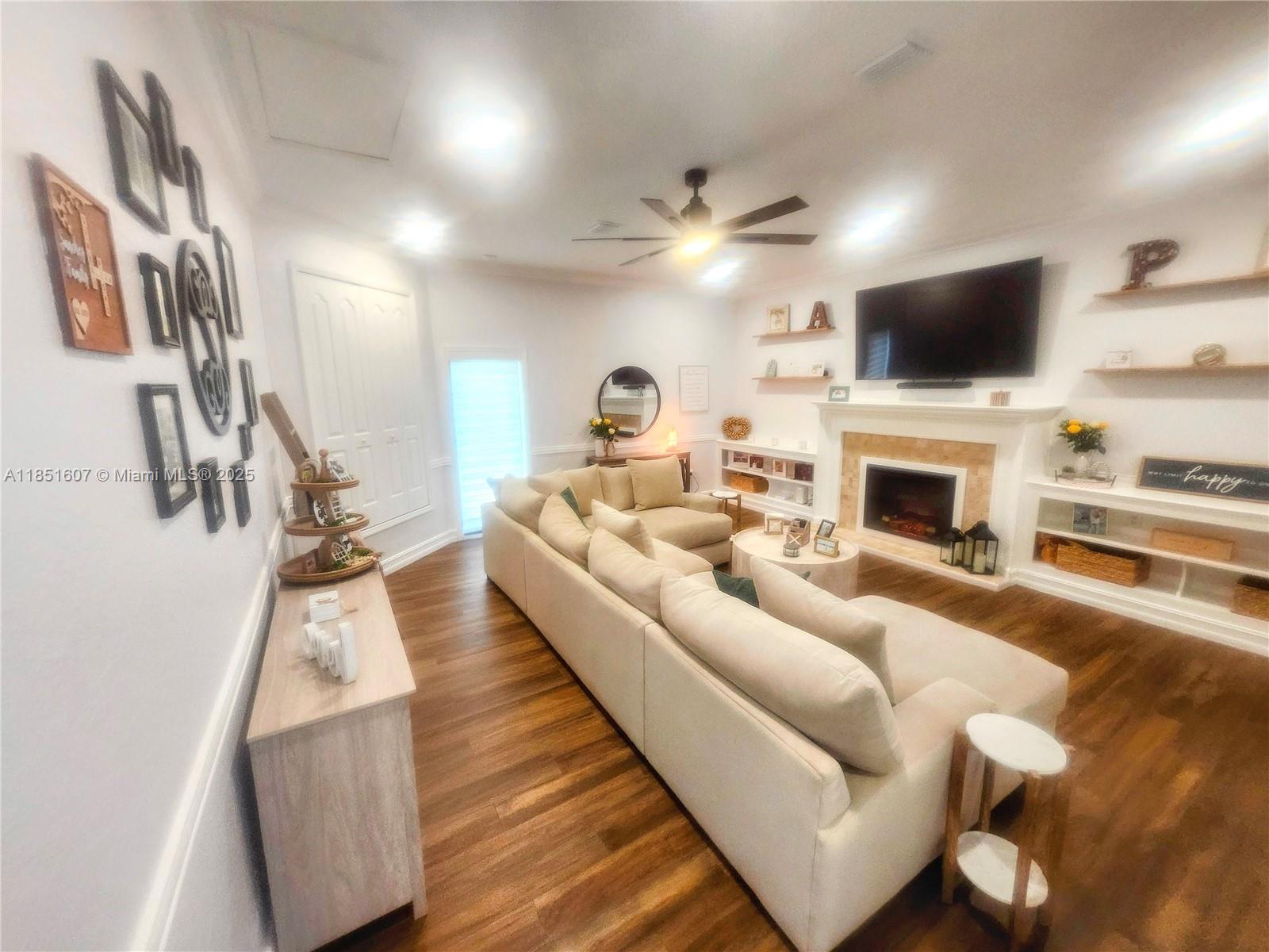 17833 Southwest 155th Court Miami, FL 33187 - Photo 18 of 22 a living room with furniture and a flat screen tv