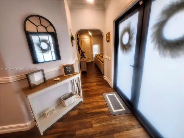 a view of living room and bathroom with wooden floor