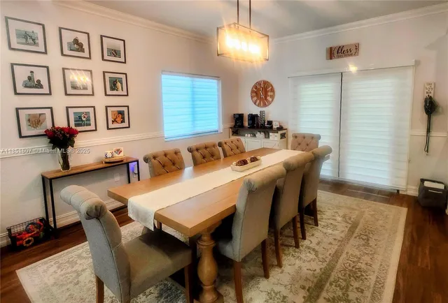 a view of a dining room with furniture and chandelier