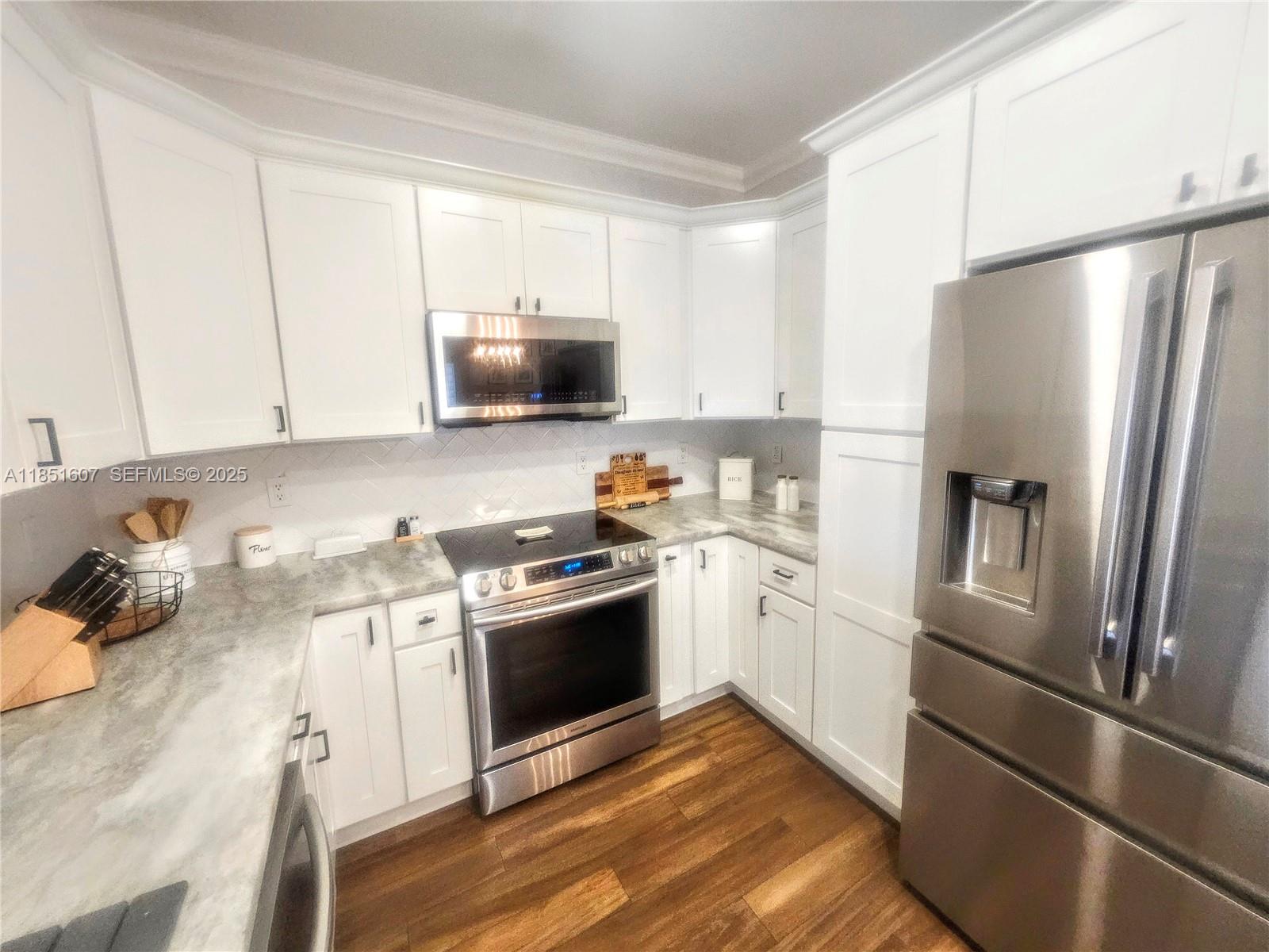17833 Southwest 155th Court Miami, FL 33187 - Photo 7 of 22 a kitchen with a refrigerator stove and sink