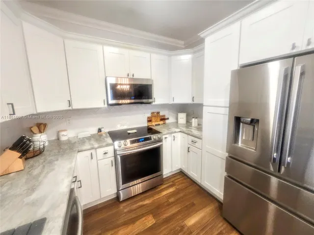 a kitchen with a refrigerator stove and microwave