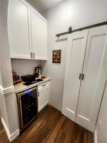 a kitchen with white cabinets and white appliances