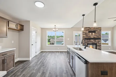 a view of empty room with wooden floor and ceiling fan