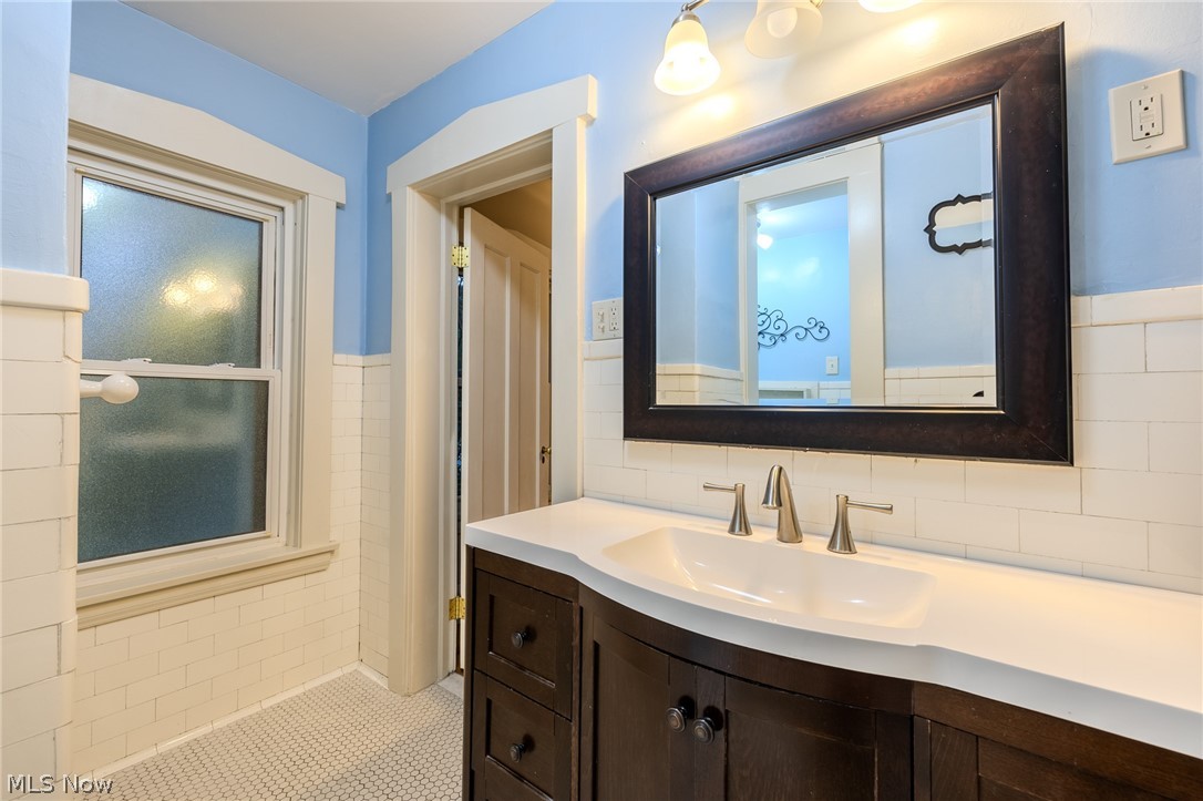 2472 Overlook Road Cleveland Heights, OH 44106 - Photo 25 of 30 Bathroom with vanity, tile walls, a wainscoted wall, and tile patterned floors