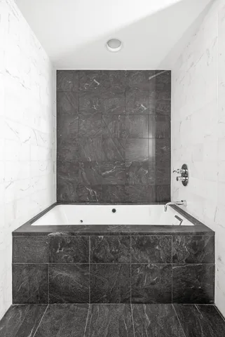a bathroom with a granite countertop sink toilet mirror vanity and shower