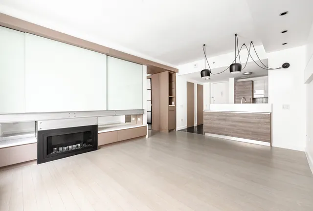 a view of a kitchen with a refrigerator and a sink
