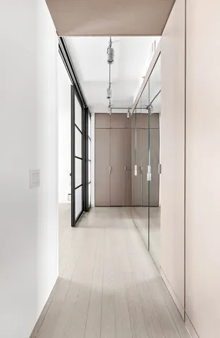 a view of a room with racks on the wall and a window