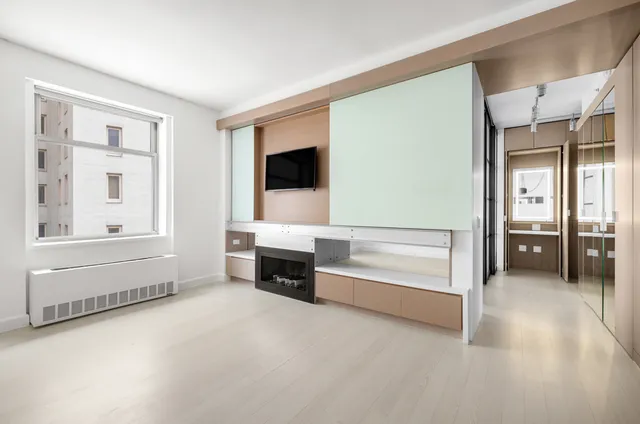 an empty room with windows and entryway