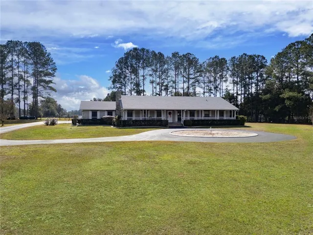 a view of a house with a yard and swimming pool