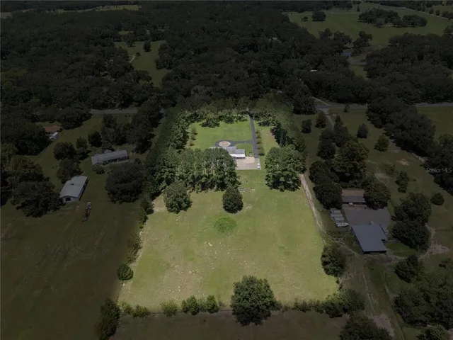 a view of yard with swimming pool and green space