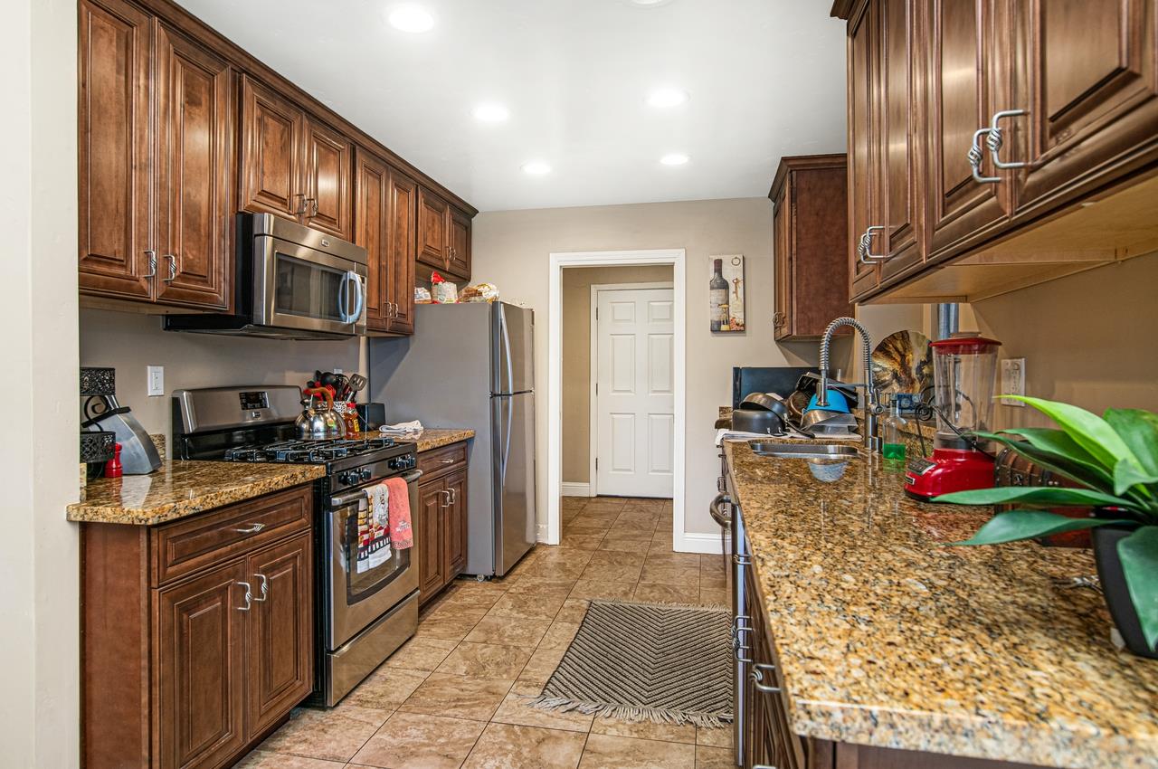 5644 Schooner Loop Discovery Bay, CA 94505 - Photo 12 of 42 a kitchen with stainless steel appliances granite countertop a refrigerator stove and sink