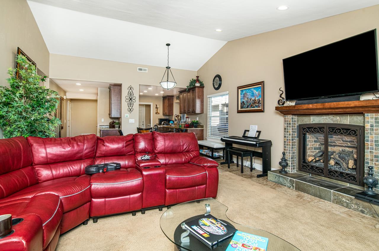 5644 Schooner Loop Discovery Bay, CA 94505 - Photo 20 of 42 a living room with furniture a flat screen tv and a fireplace