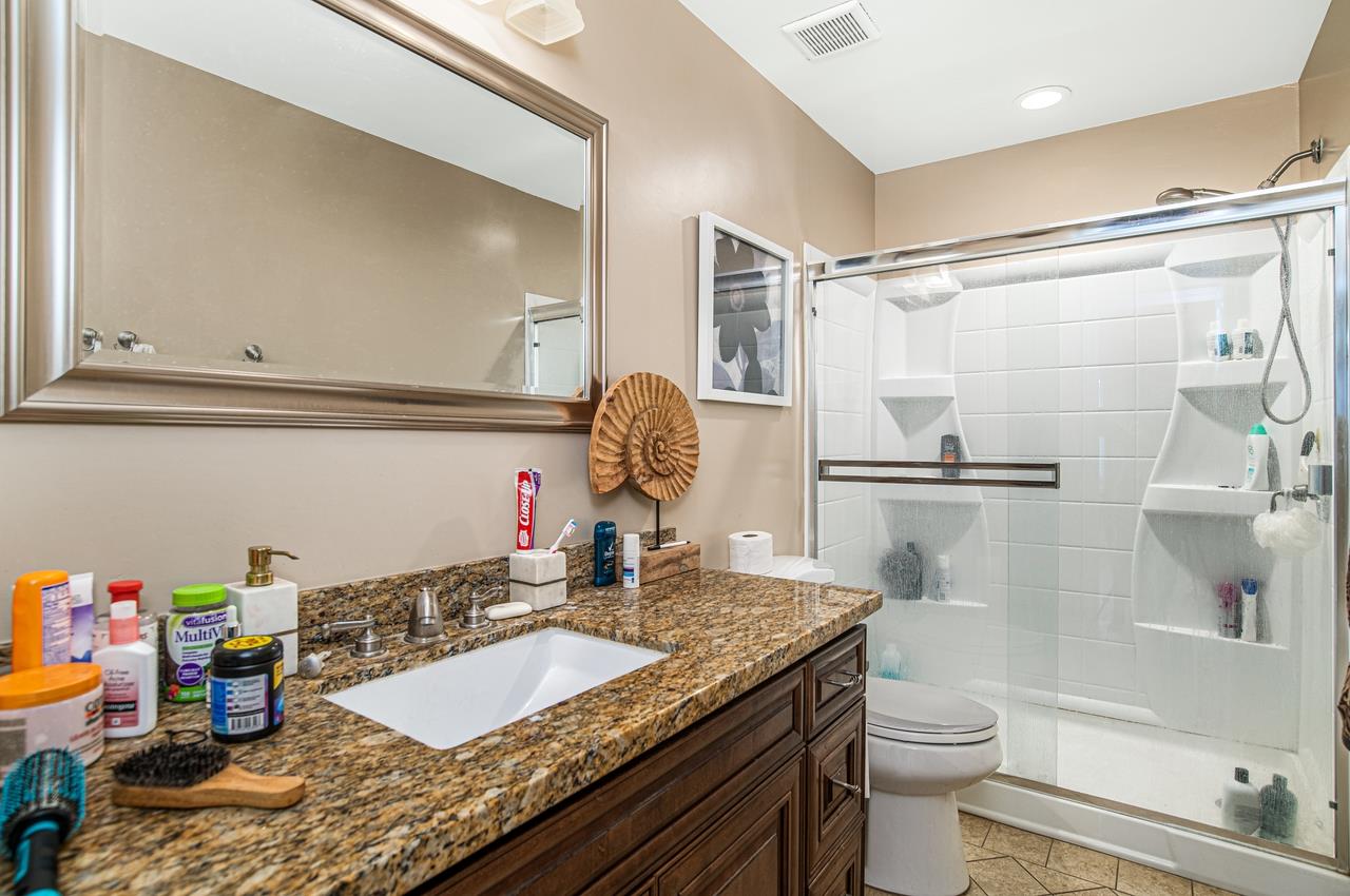 5644 Schooner Loop Discovery Bay, CA 94505 - Photo 22 of 42 a bathroom with a granite countertop sink toilet and shower