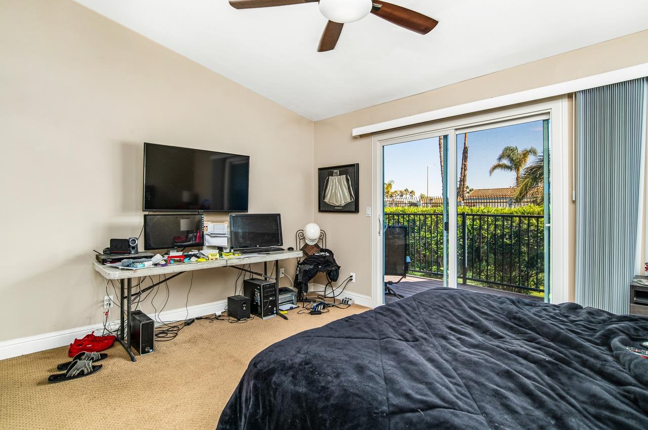 5644 Schooner Loop Discovery Bay, CA 94505 - Photo 25 of 42 a bedroom that has a bed computer on desk and a large window