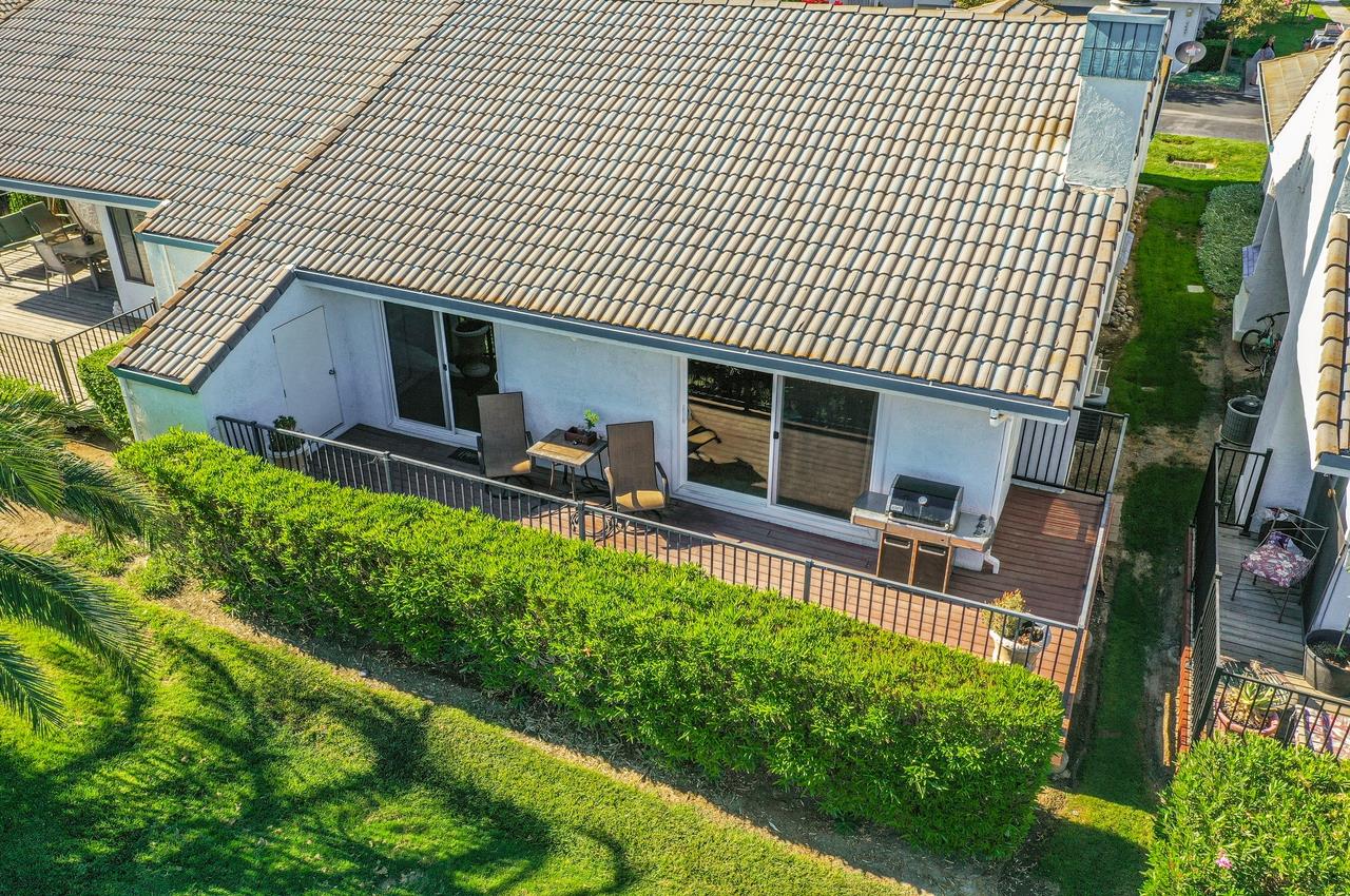 5644 Schooner Loop Discovery Bay, CA 94505 - Photo 36 of 42 a backyard of a house with table and chairs wooden floor and fence