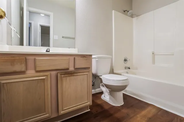 a bathroom with a toilet a sink and bathtub