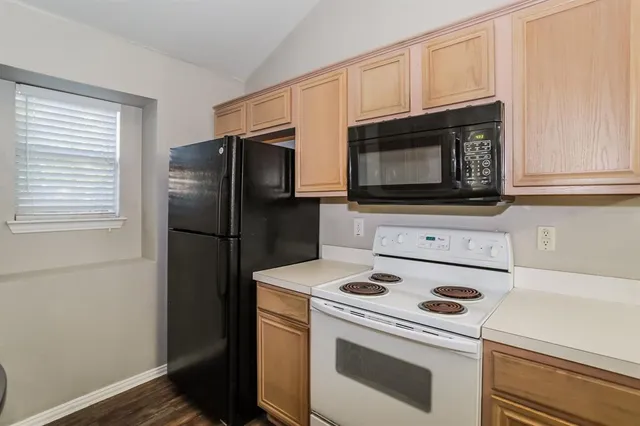 a kitchen with a microwave stove and refrigerator
