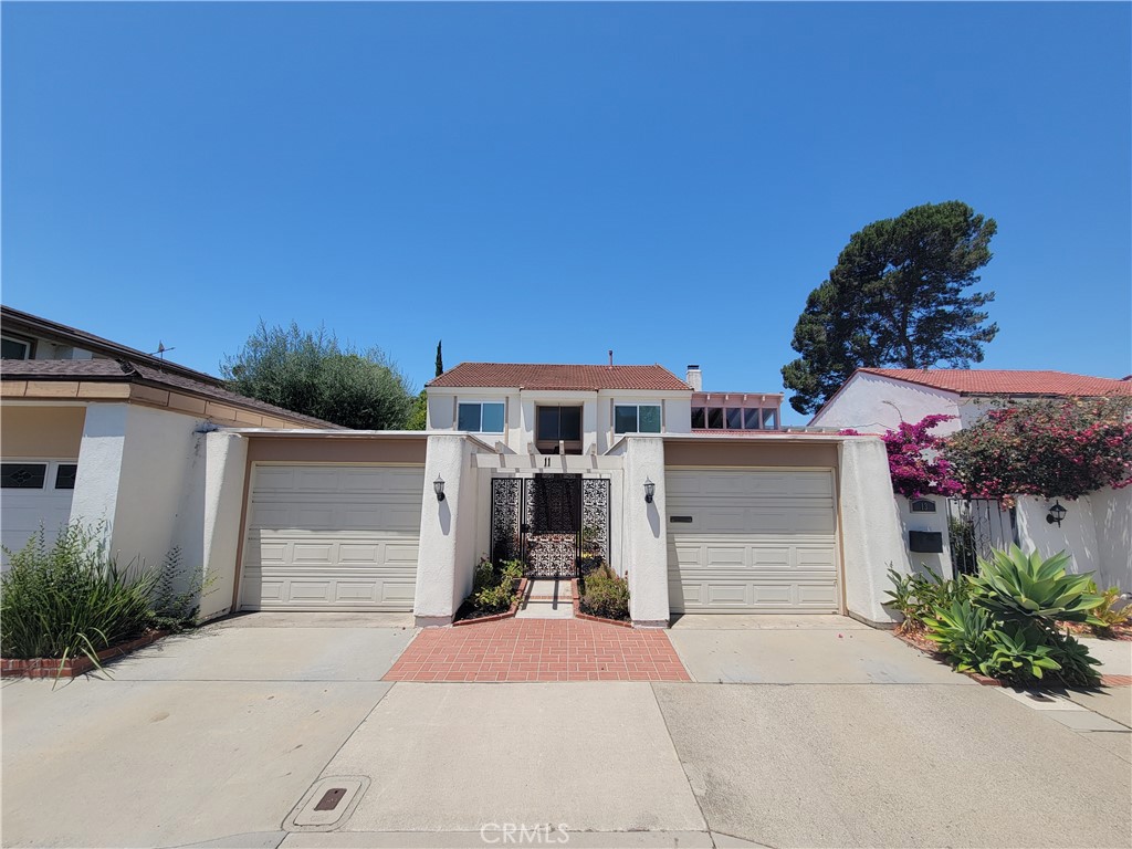 11 Meadowsweet Way Irvine, CA 92612 - Photo 1 of 35 a front view of a house with a yard and garage