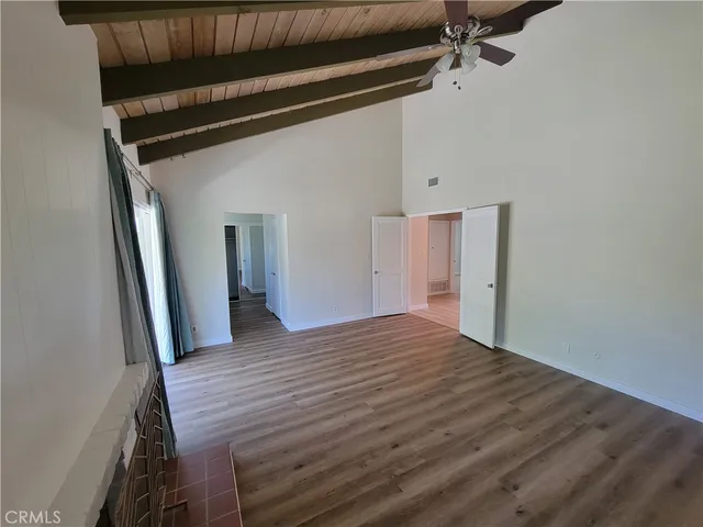a view of a room with wooden floor