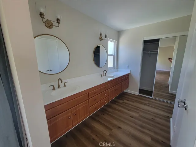 a bathroom with a double vanity sink and a mirror
