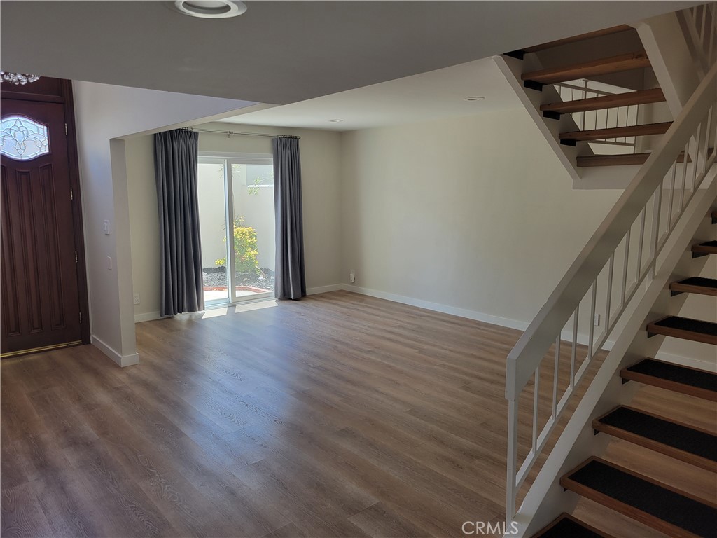 11 Meadowsweet Way Irvine, CA 92612 - Photo 4 of 35 a view of an empty room with wooden floor and stairs