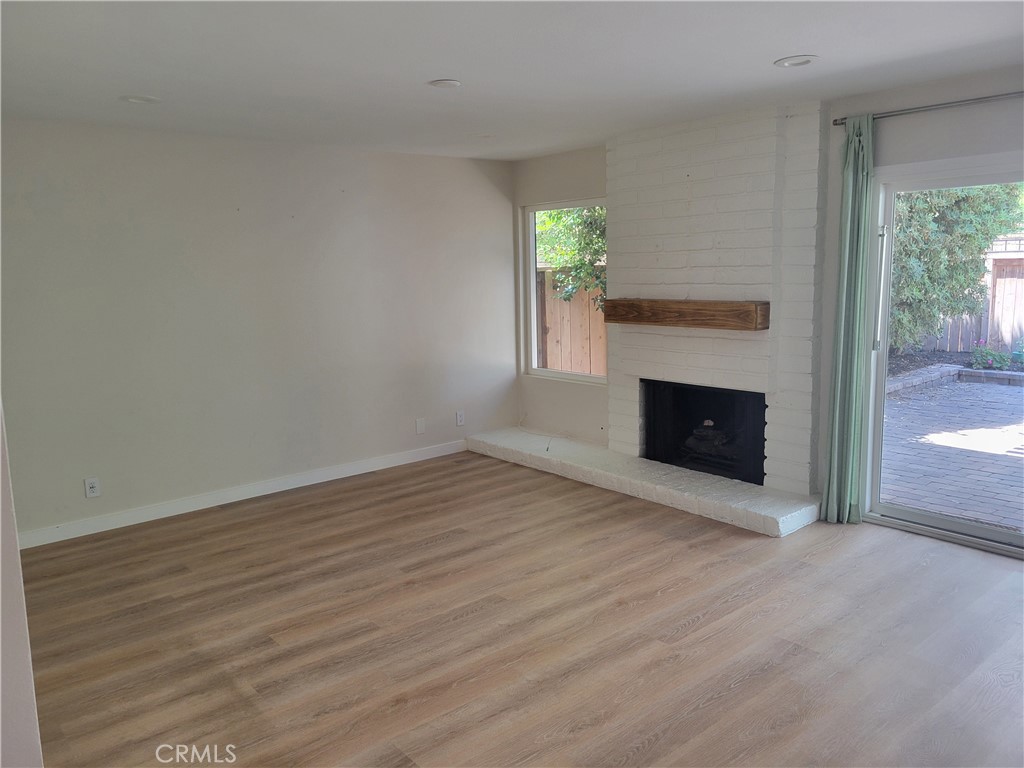 11 Meadowsweet Way Irvine, CA 92612 - Photo 6 of 35 a view of empty room with wooden floor and fireplace