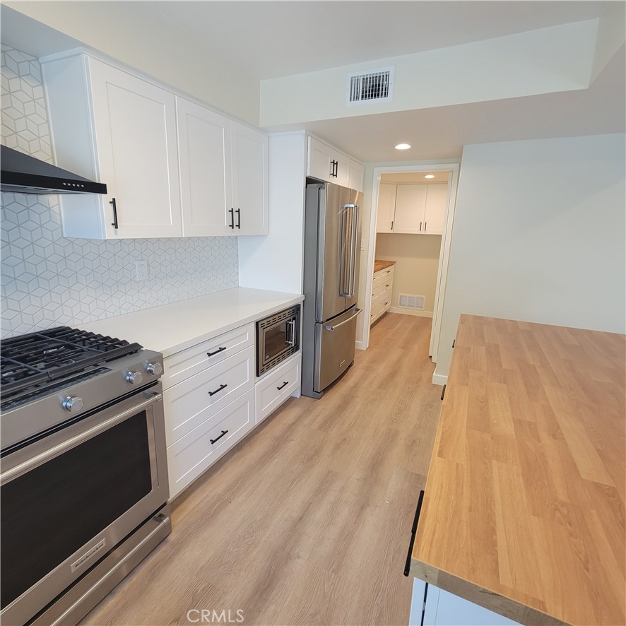 11 Meadowsweet Way Irvine, CA 92612 - Photo 9 of 35 a kitchen with granite countertop a stove and a refrigerator