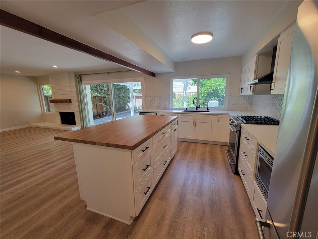 11 Meadowsweet Way Irvine, CA 92612 - Photo 10 of 35 a kitchen with granite countertop a sink appliances wooden floor and cabinets