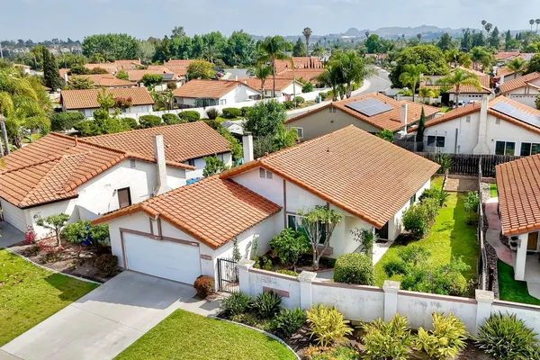a aerial view of a house with a yard and potted plants