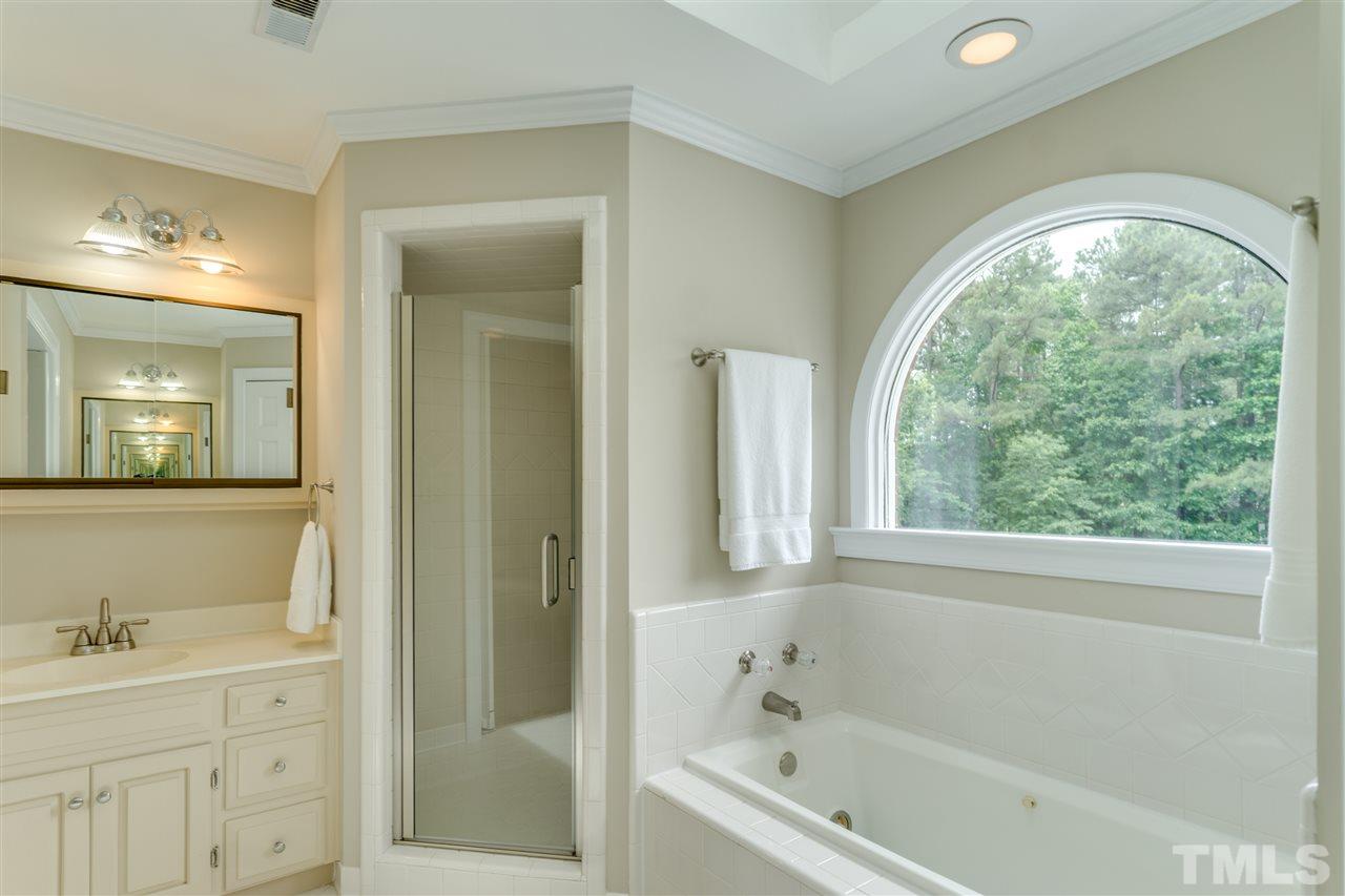 3905 Inland Court Raleigh, NC 27606 - Photo 14 of 24 The Master bathroom includes a step-in shower, champagne bathtub, separate His & Her's vanities and private water closet!