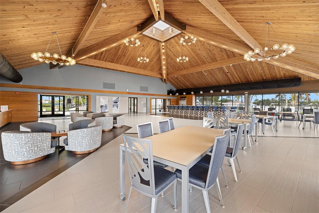 9495 Blind Pass Road, Unit 202 St. Pete Beach, FL 33706 - Photo 35 of 55 a view of a dining room with furniture and wooden floor