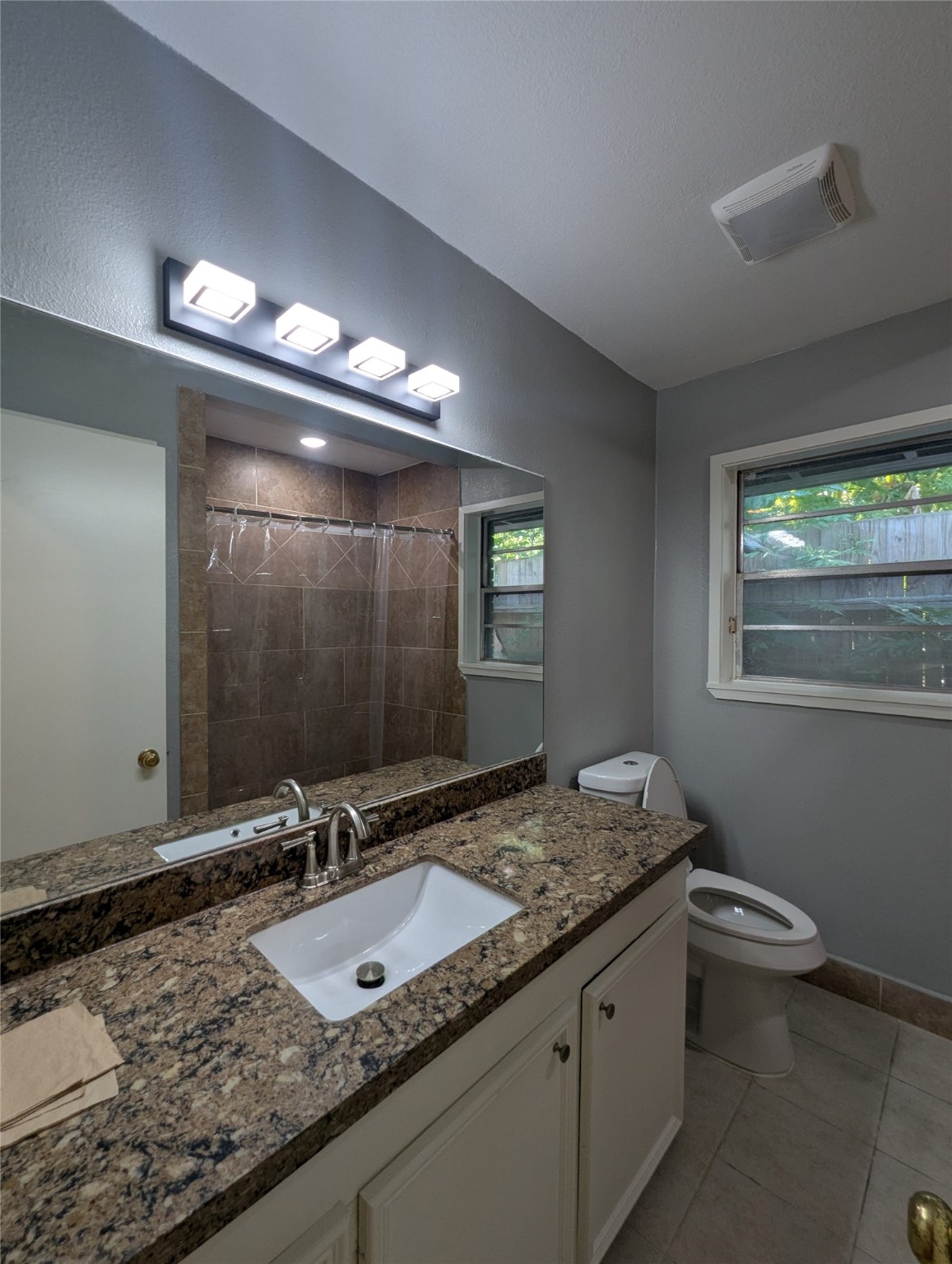 12633 Arp Street Houston, TX 77085 - Photo 11 of 11 a bathroom with a granite countertop sink and a mirror