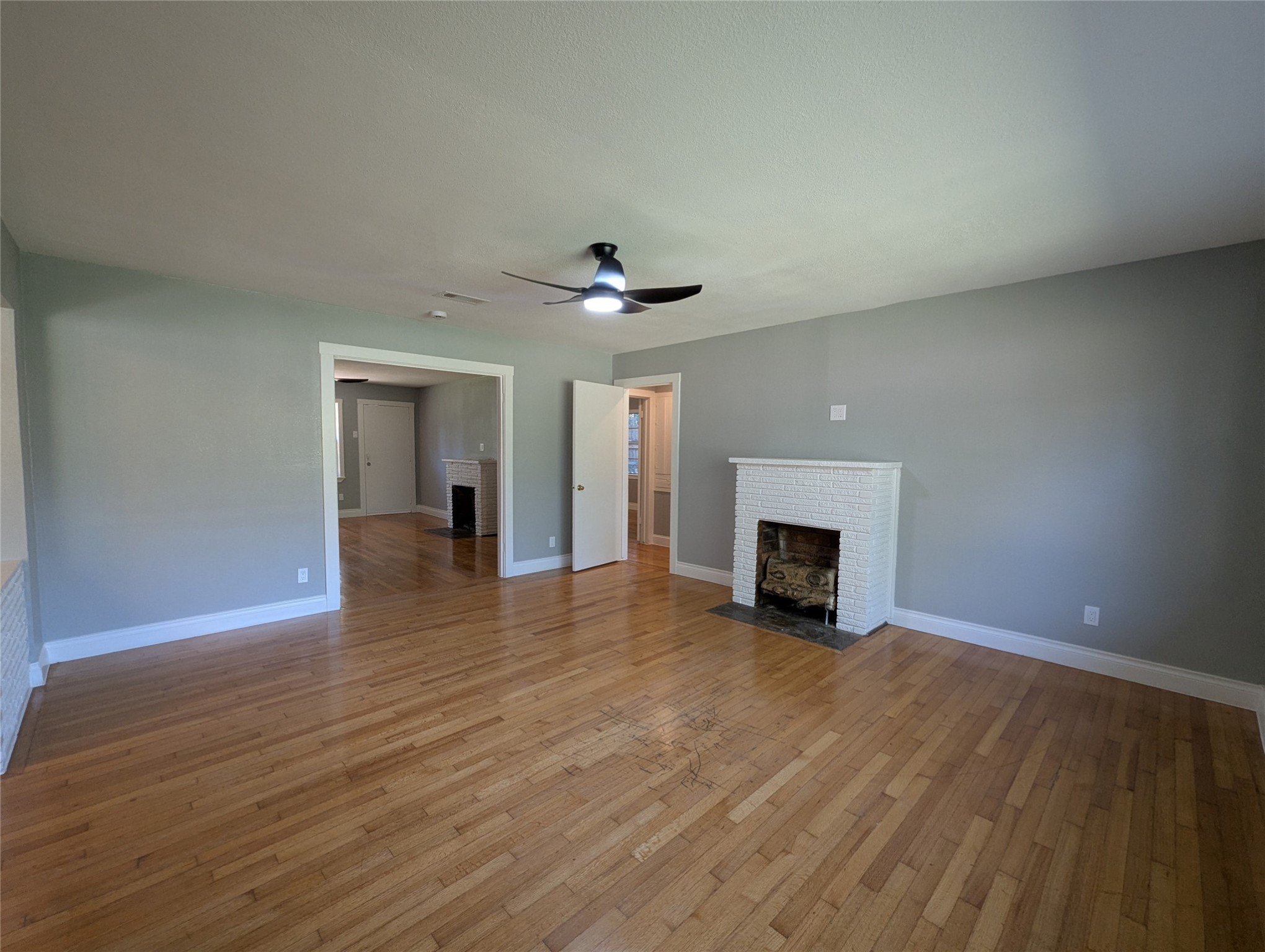 12633 Arp Street Houston, TX 77085 - Photo 3 of 11 a view of a livingroom with wooden floor a fireplace and window