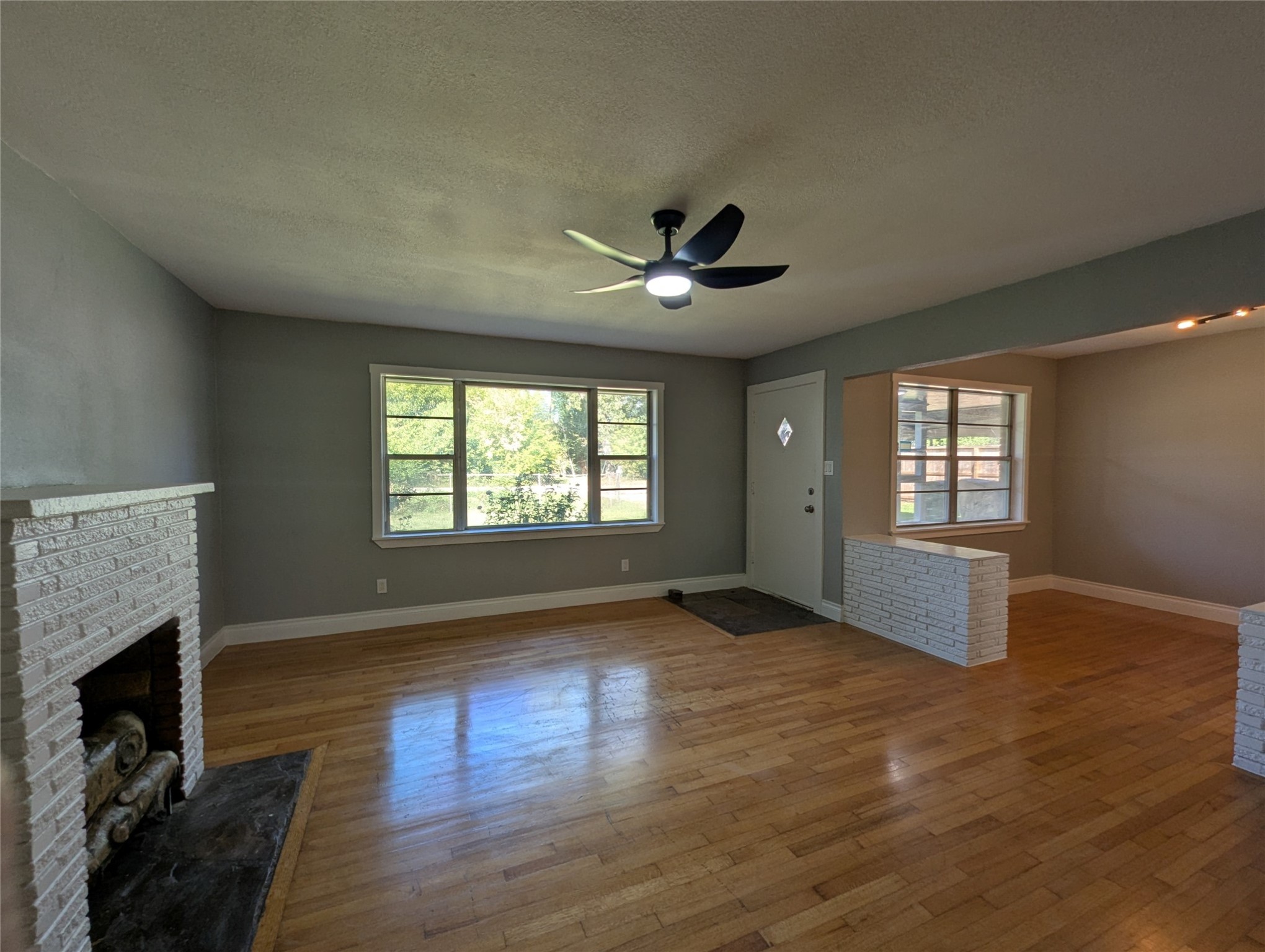 12633 Arp Street Houston, TX 77085 - Photo 4 of 11 a view of an empty room with wooden floor and a window