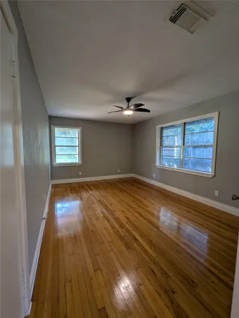 wooden floor in an empty room with a window