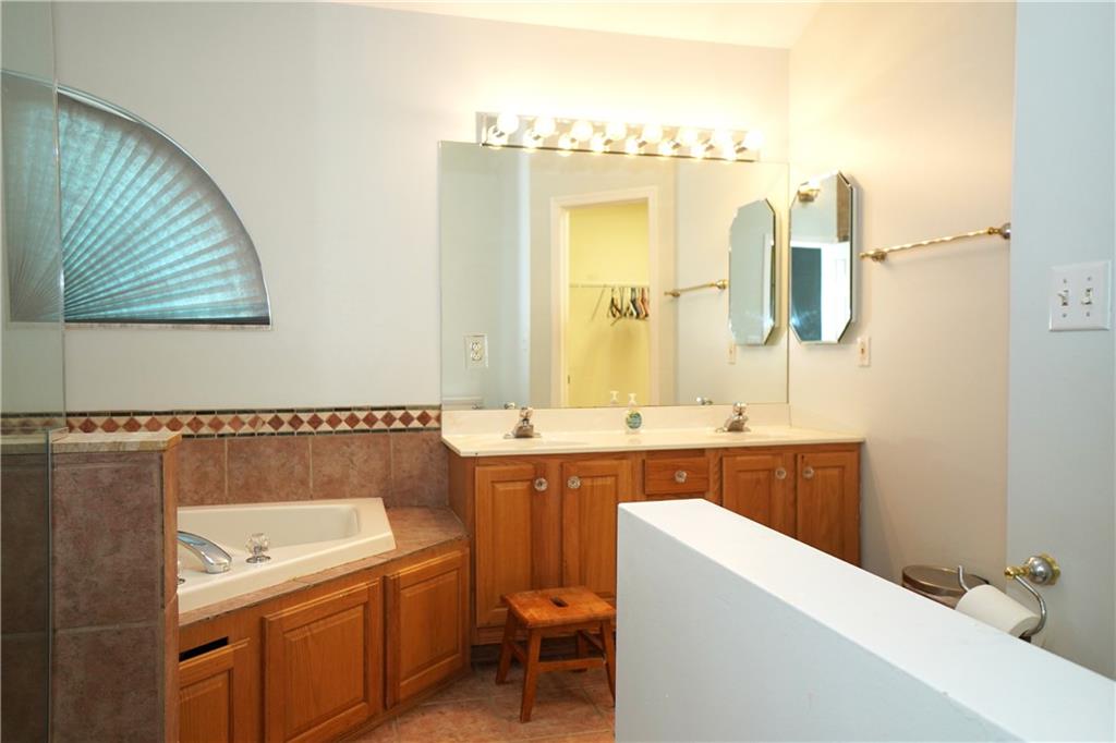 728 Mercer Street Pittsburgh, PA 15219 - Photo 14 of 27 a bathroom with a granite countertop sink a toilet and bathtub