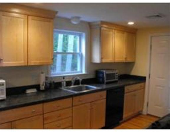 126 Lowell Road Pepperell, MA 01463 - Photo 3 of 16 a kitchen with granite countertop white cabinets sink and window