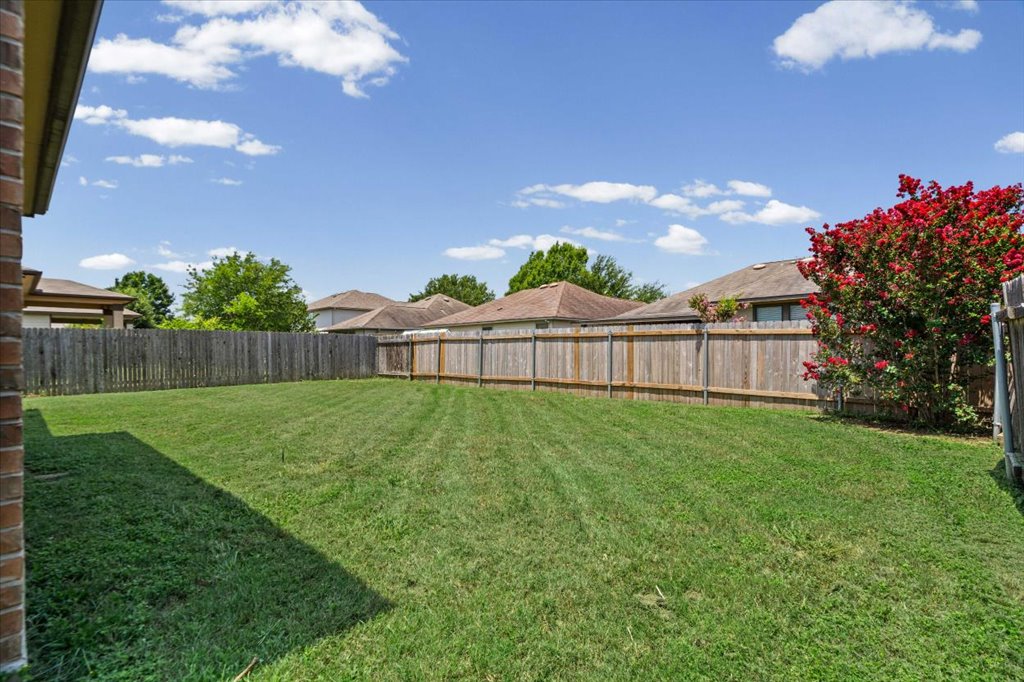 8804 Capitol View Drive Austin, TX 78747 - Photo 18 of 32 a view of a backyard with a garden and wooden fence