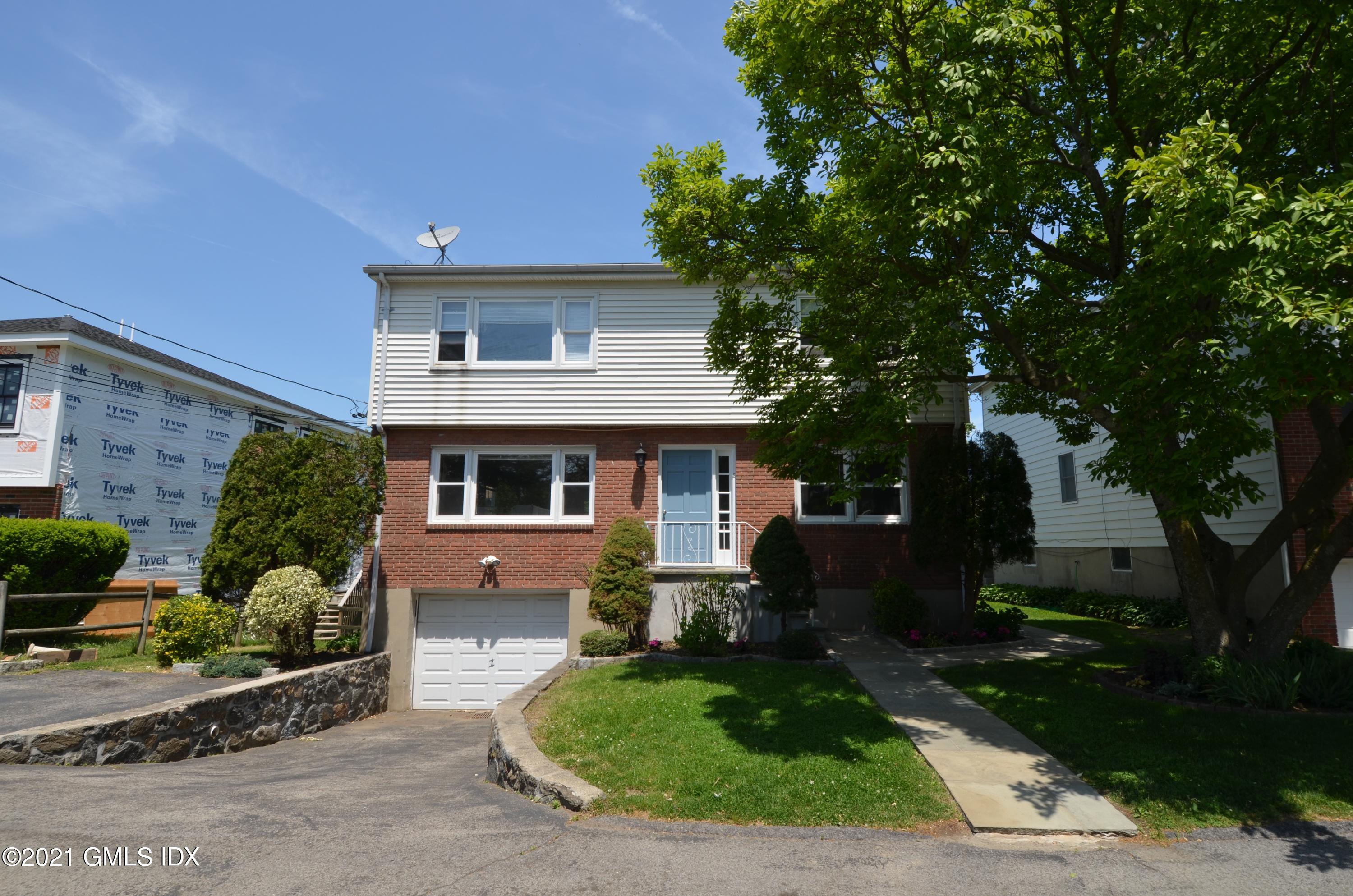 5 Ridge Place, Unit 1 Greenwich, CT 06831 - Photo 2 of 29 a front view of a house with garden