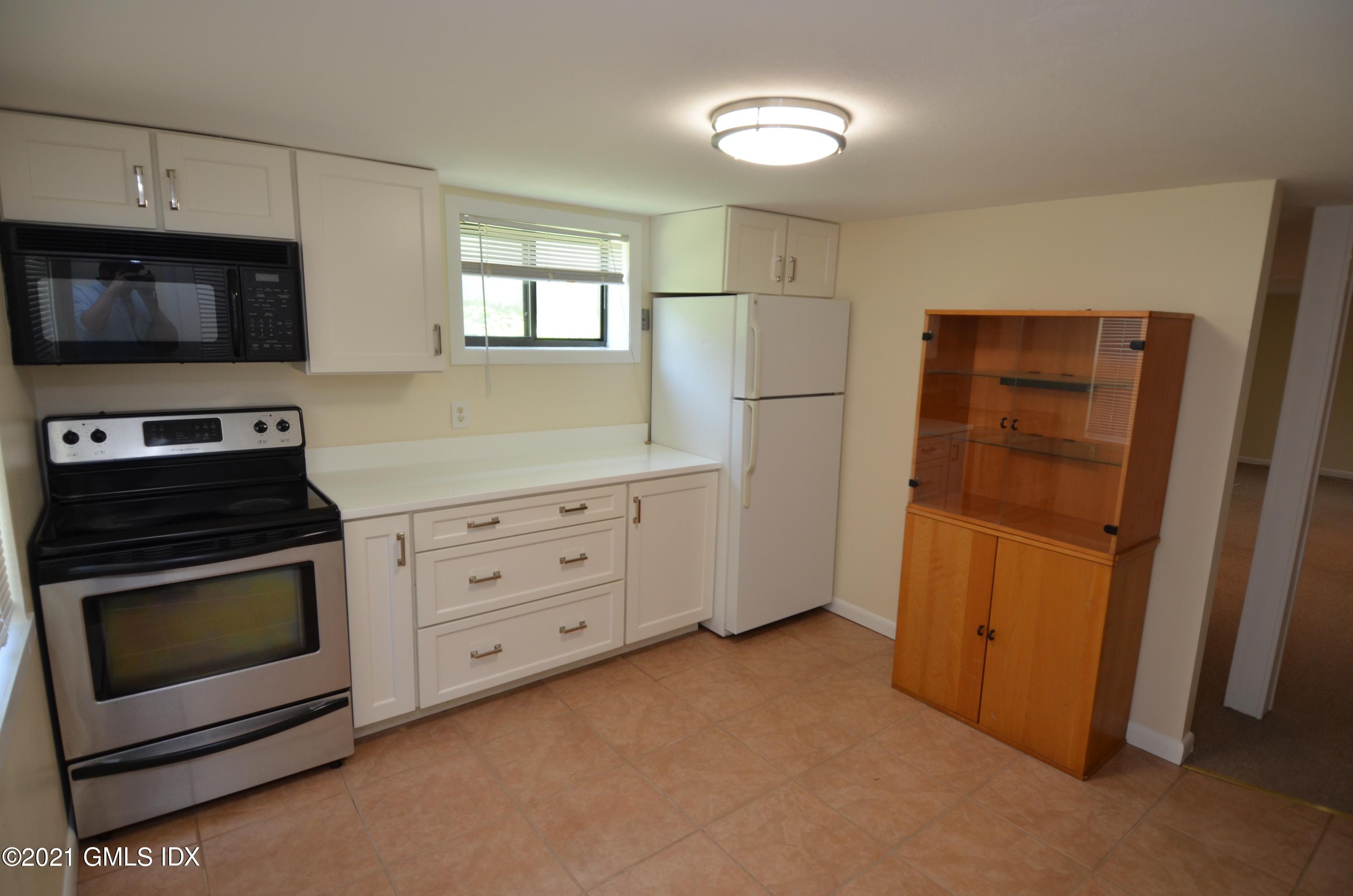 5 Ridge Place, Unit 1 Greenwich, CT 06831 - Photo 21 of 29 a kitchen with cabinets and steel stainless steel appliances