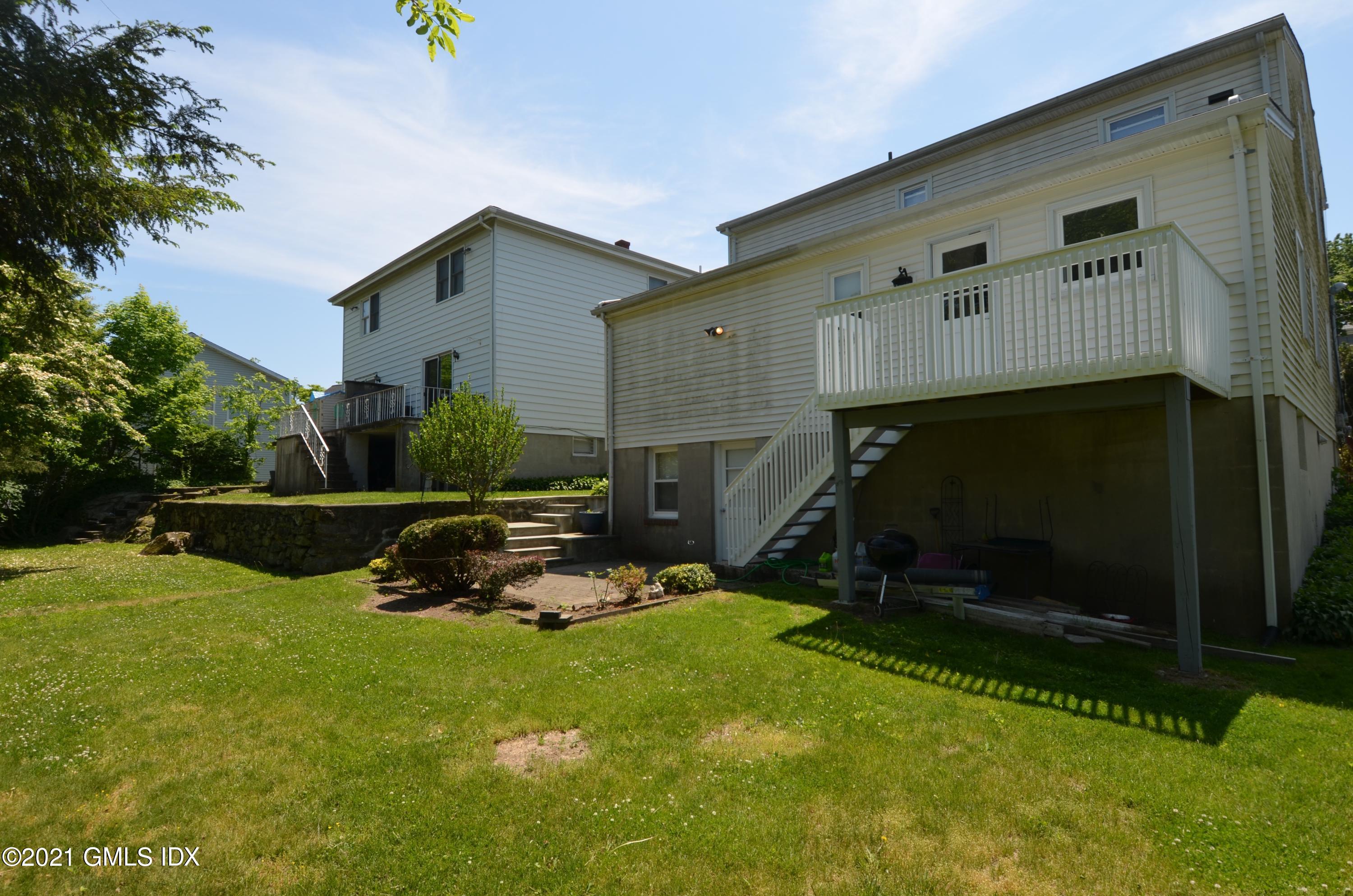 5 Ridge Place, Unit 1 Greenwich, CT 06831 - Photo 26 of 29 a view of a house with backyard and sitting area