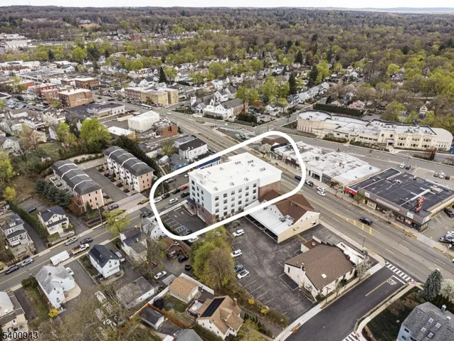 an aerial view of residential houses with city view