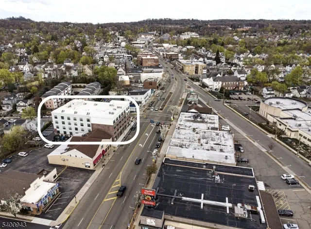 an aerial view of a residential apartment building with a city view