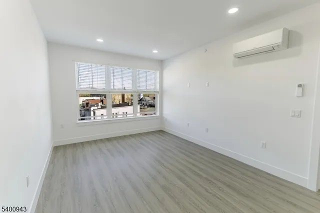 a view of a room with wooden floor and window