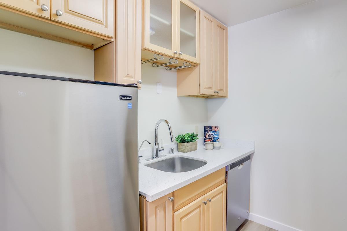 3003 Kaiser Drive, Unit D Santa Clara, CA 95051 - Photo 9 of 20 a kitchen with stainless steel appliances a sink and cabinets