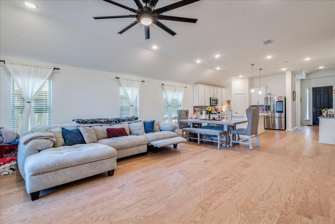 409 Durian Loop Buda, TX 78610 - Photo 10 of 30 Living area featuring light wood finished floors, recessed lighting, a ceiling fan, and lofted ceiling