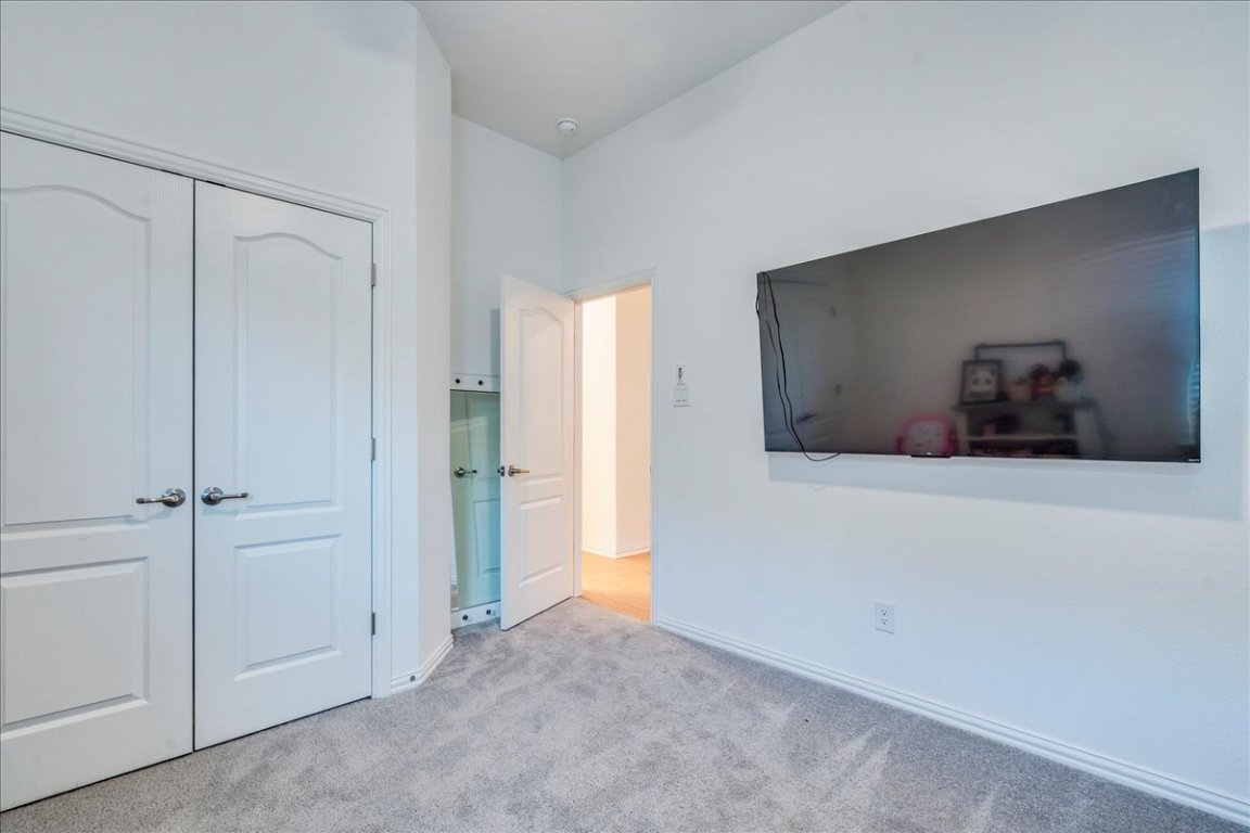 409 Durian Loop Buda, TX 78610 - Photo 19 of 30 Bedroom featuring a closet and carpet floors