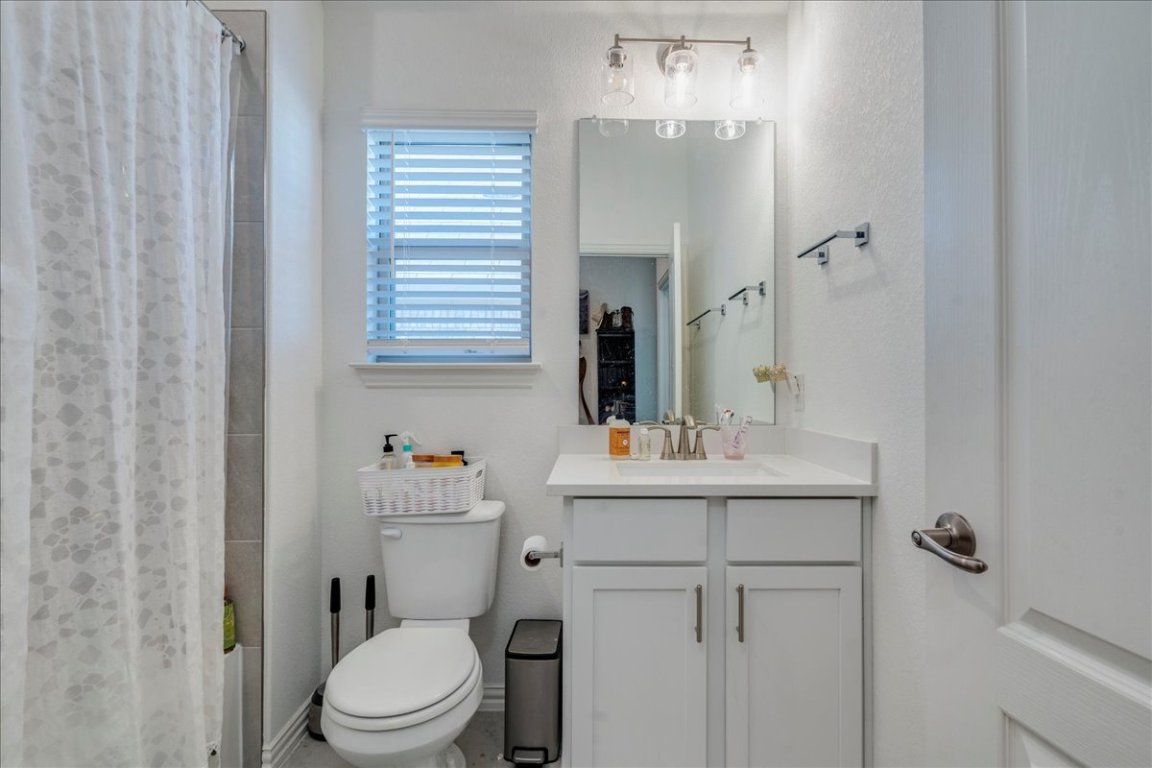409 Durian Loop Buda, TX 78610 - Photo 23 of 30 Bathroom featuring vanity and a shower with curtain