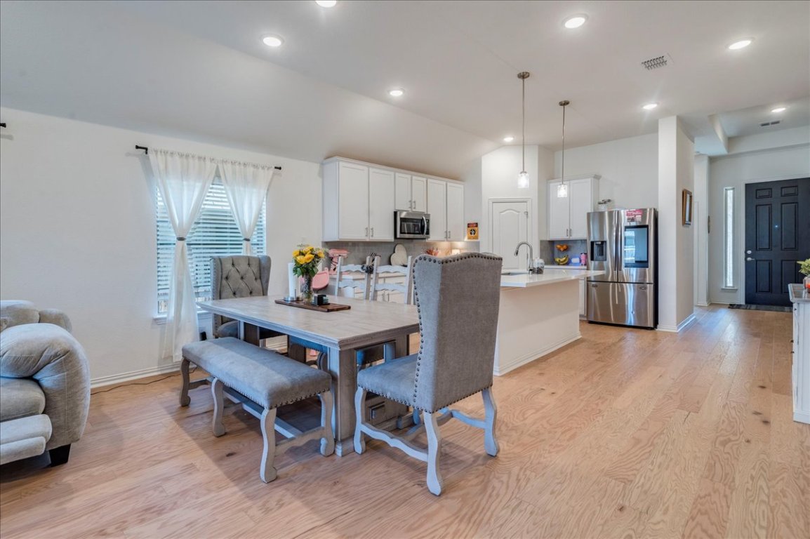 409 Durian Loop Buda, TX 78610 - Photo 7 of 30 Dining space with light wood-style floors, recessed lighting, and vaulted ceiling